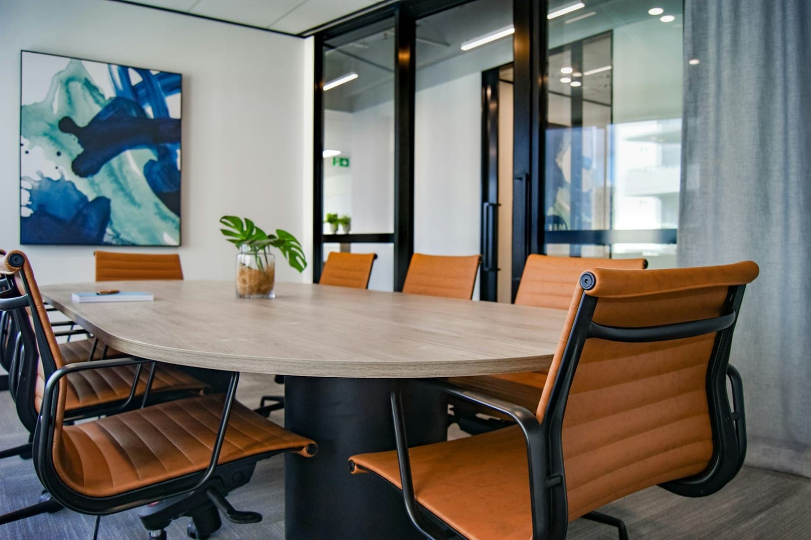 A meeting table with leather chairs, ready for a session